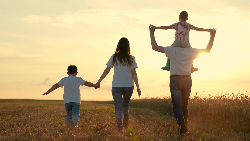 Family walking through field